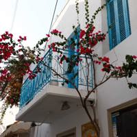 island town white balcony with red flowers