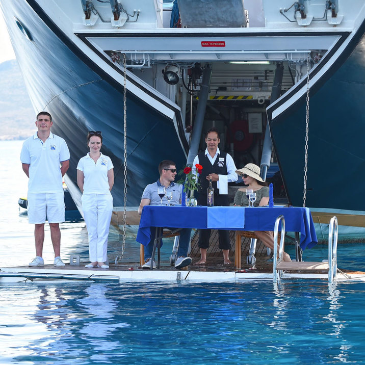 guests on apparel with waiter and crew