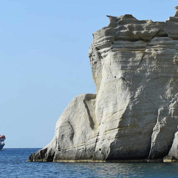 ship near high rocky coast 