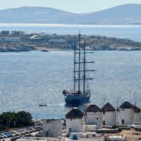 ship next to Mykonos coast and town windmills