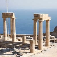 temple column ruins on rocky island hilltop