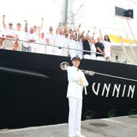 Whole crew and captain standing and waving from the ship