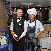 chef and waiter in the restaurant with wine bottle