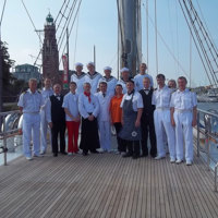 full crew on the ship deck in harbor