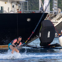 guest wakeboarding next to ship and apparel
