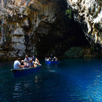 guests on boats netering coastal cave