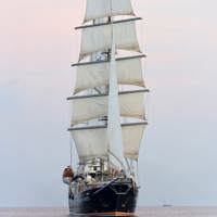 ship at sea at full sails front view